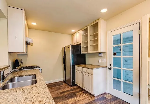 an empty room with wooden floor and fireplace