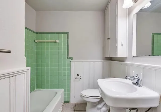an empty room with wooden floor chandelier fan and closet area