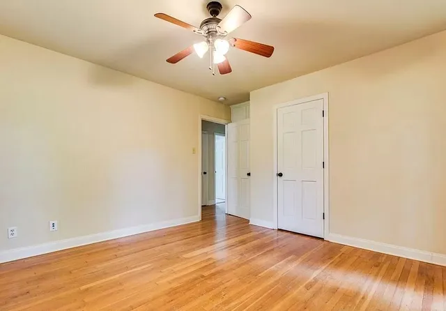 a view of a livingroom with a flat screen tv and wooden floor