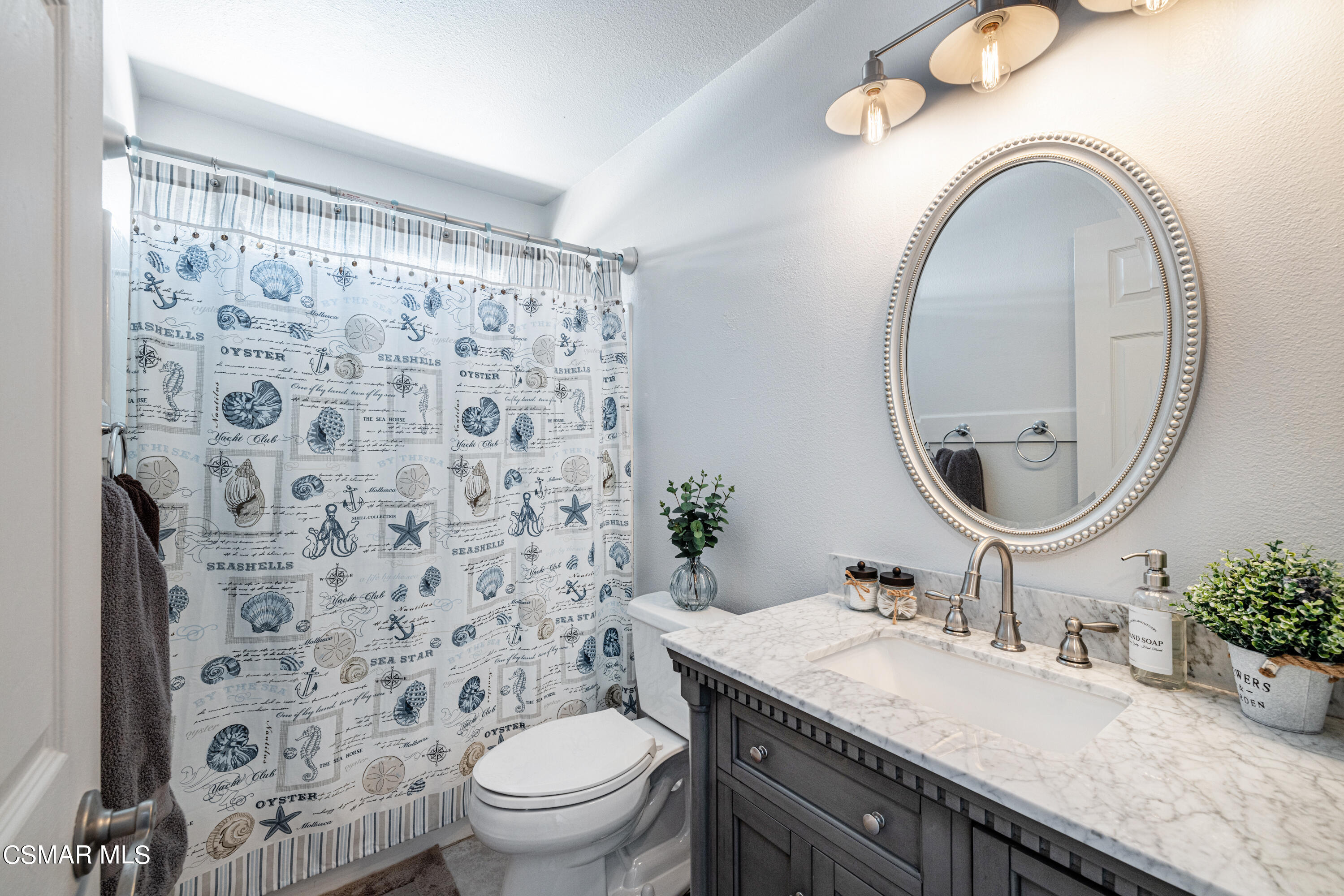 2087 Chenault Place Simi Valley, CA 93065 - Photo 20 of 36 a bathroom with a granite countertop toilet a sink and a mirror