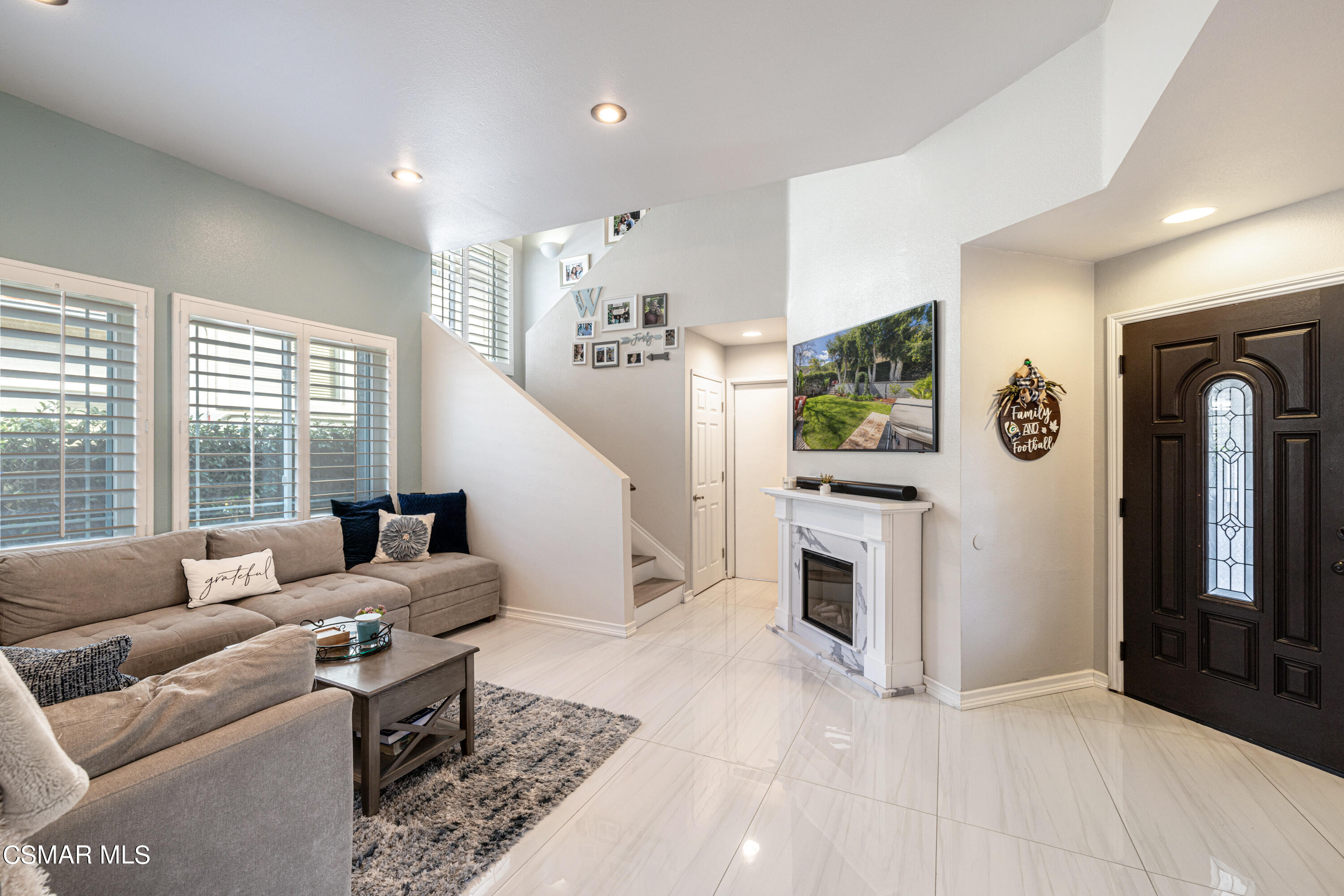 2087 Chenault Place Simi Valley, CA 93065 - Photo 10 of 36 a living room with furniture flat screen tv and a fireplace