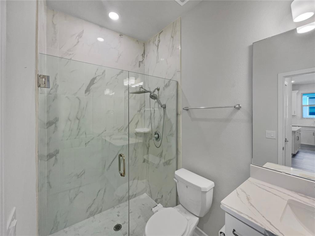 1909 Spring Shower Circle Kissimmee, FL 34744 - Photo 19 of 32 a bathroom with a toilet shower vanity and a sink