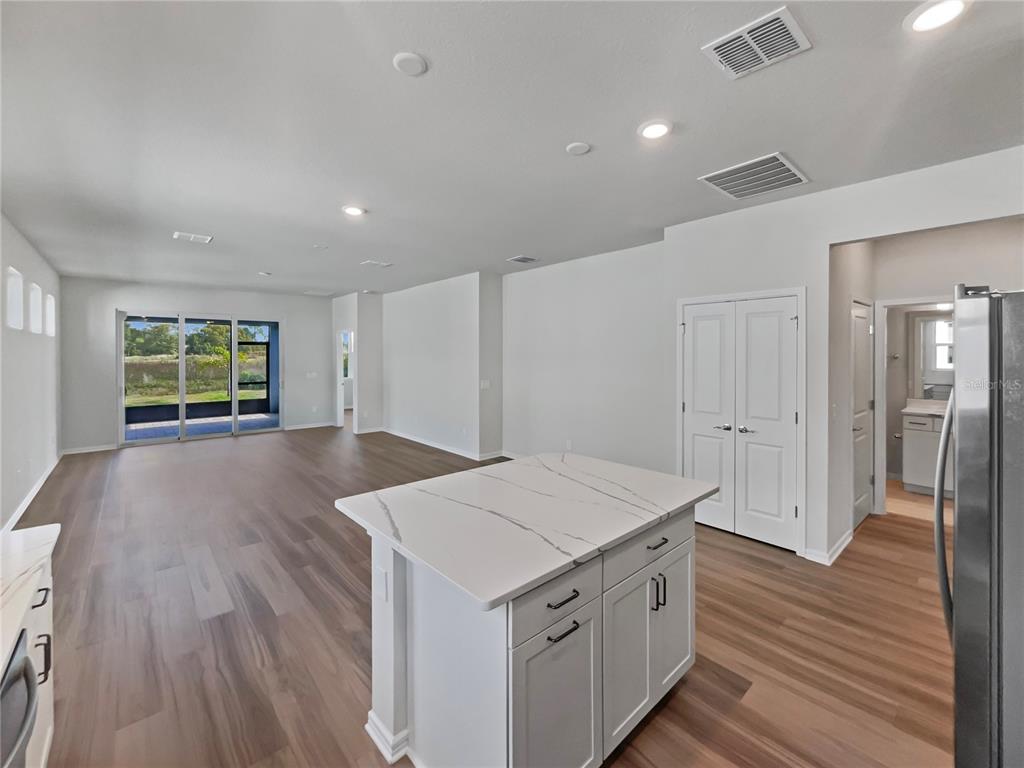 1909 Spring Shower Circle Kissimmee, FL 34744 - Photo 23 of 32 a view of a kitchen cabinets a wooden floor and entryway