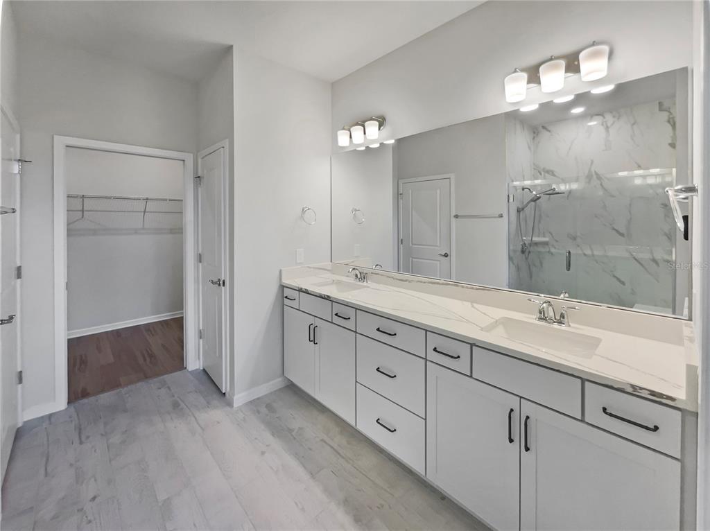 1909 Spring Shower Circle Kissimmee, FL 34744 - Photo 6 of 32 a spacious bathroom with double sink and a mirror