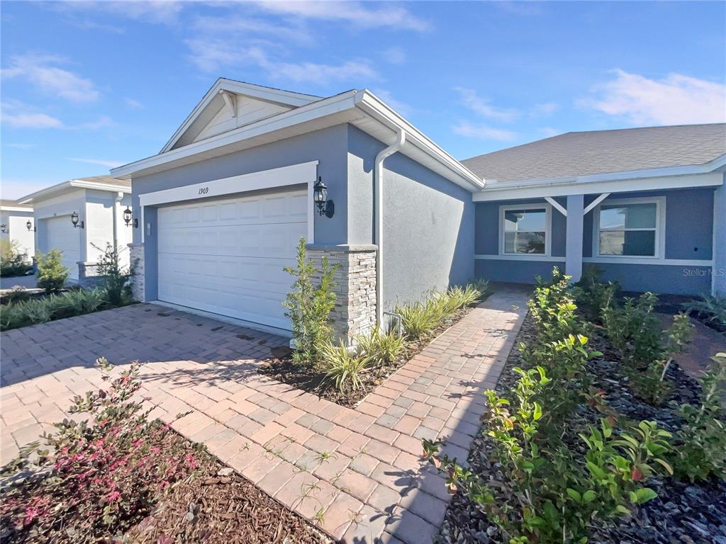 1909 Spring Shower Circle Kissimmee, FL 34744 - Photo 8 of 32 a front view of a house with garden