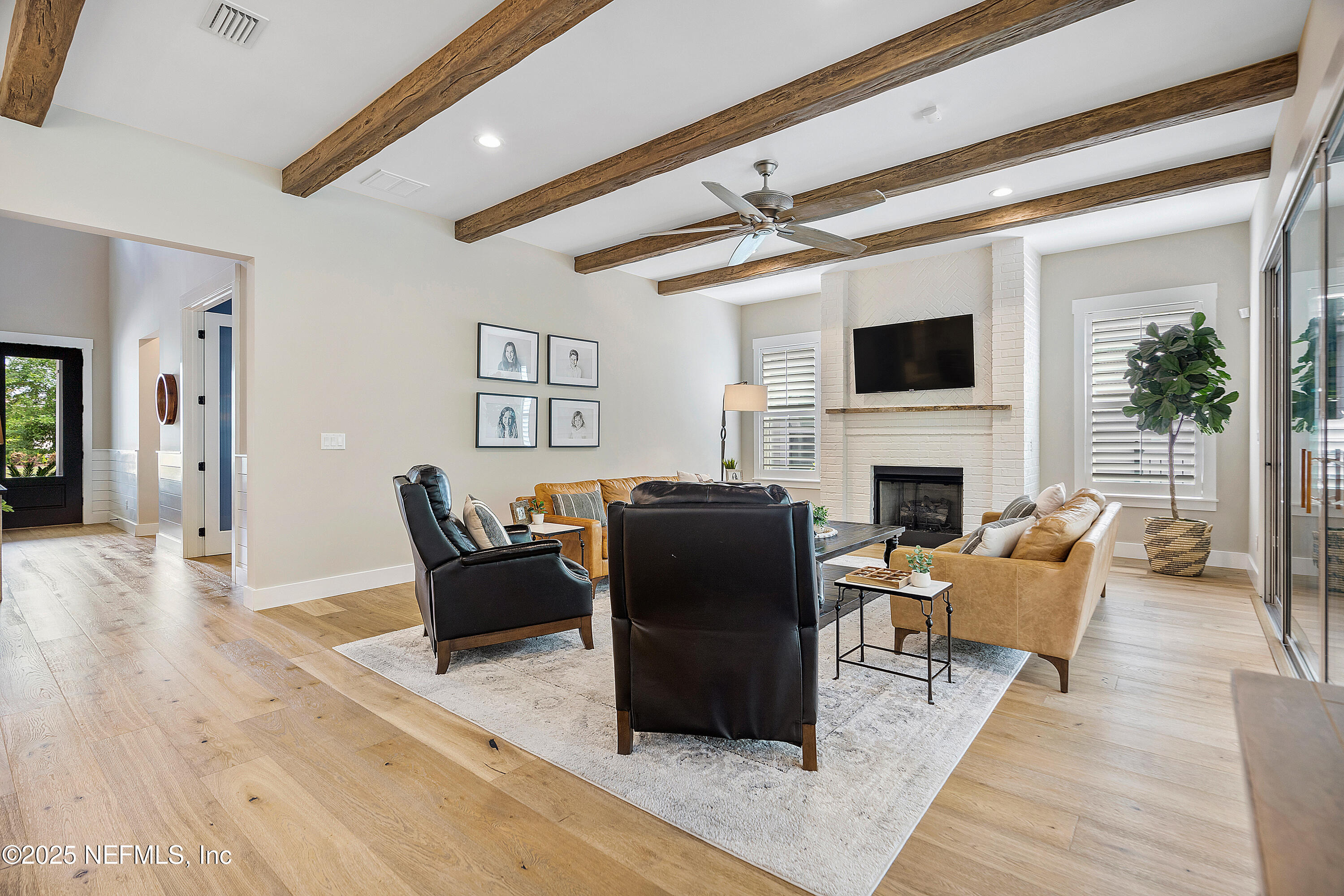 295 Seahill Drive St. Augustine, FL 32092 - Photo 18 of 101 a living room with furniture a fireplace and a flat screen tv