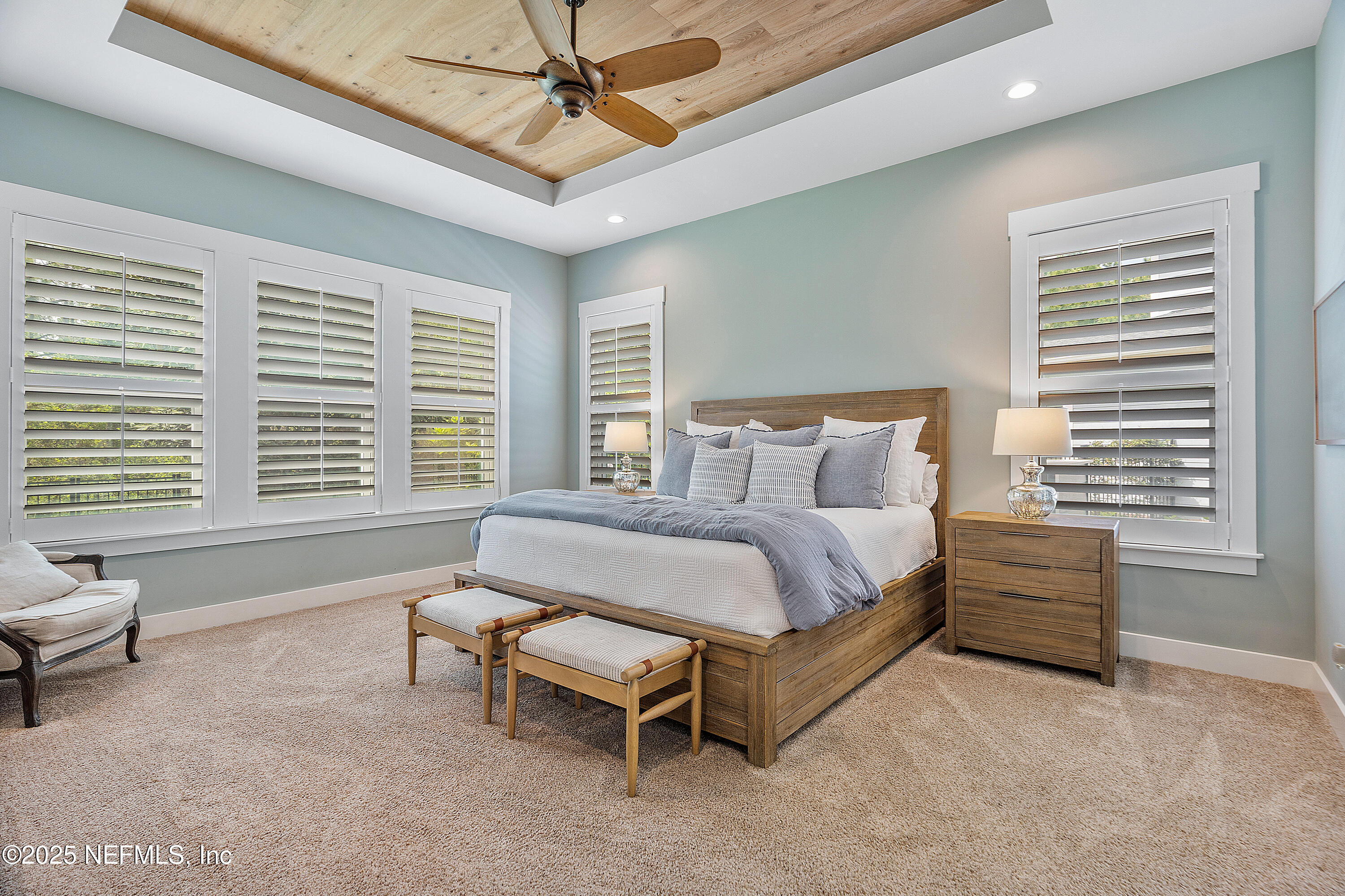 295 Seahill Drive St. Augustine, FL 32092 - Photo 43 of 101 a bedroom with a bed and a chandelier