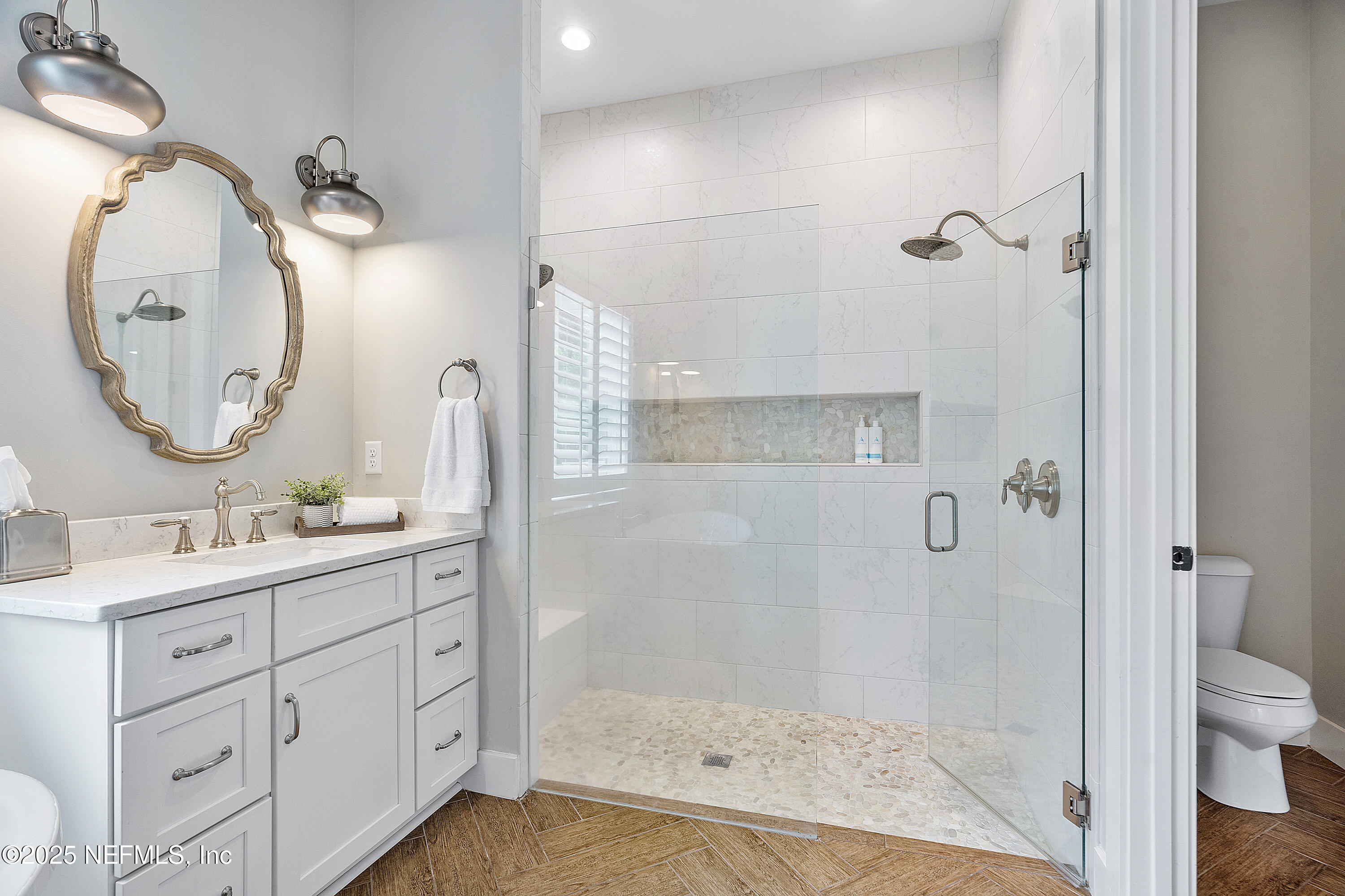 295 Seahill Drive St. Augustine, FL 32092 - Photo 49 of 101 a bathroom with a double vanity sink mirror and shower