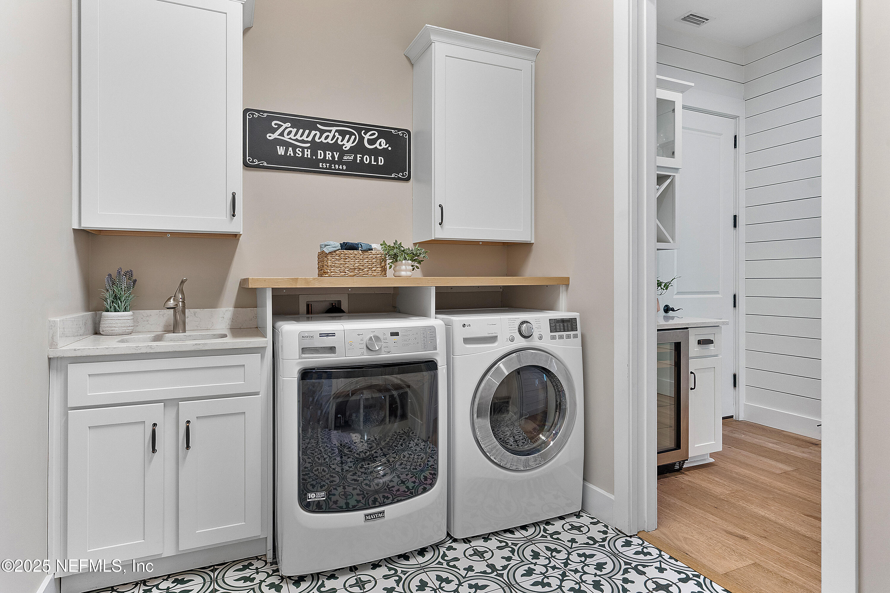 295 Seahill Drive St. Augustine, FL 32092 - Photo 54 of 101 a utility room with cabinets washer and dryer