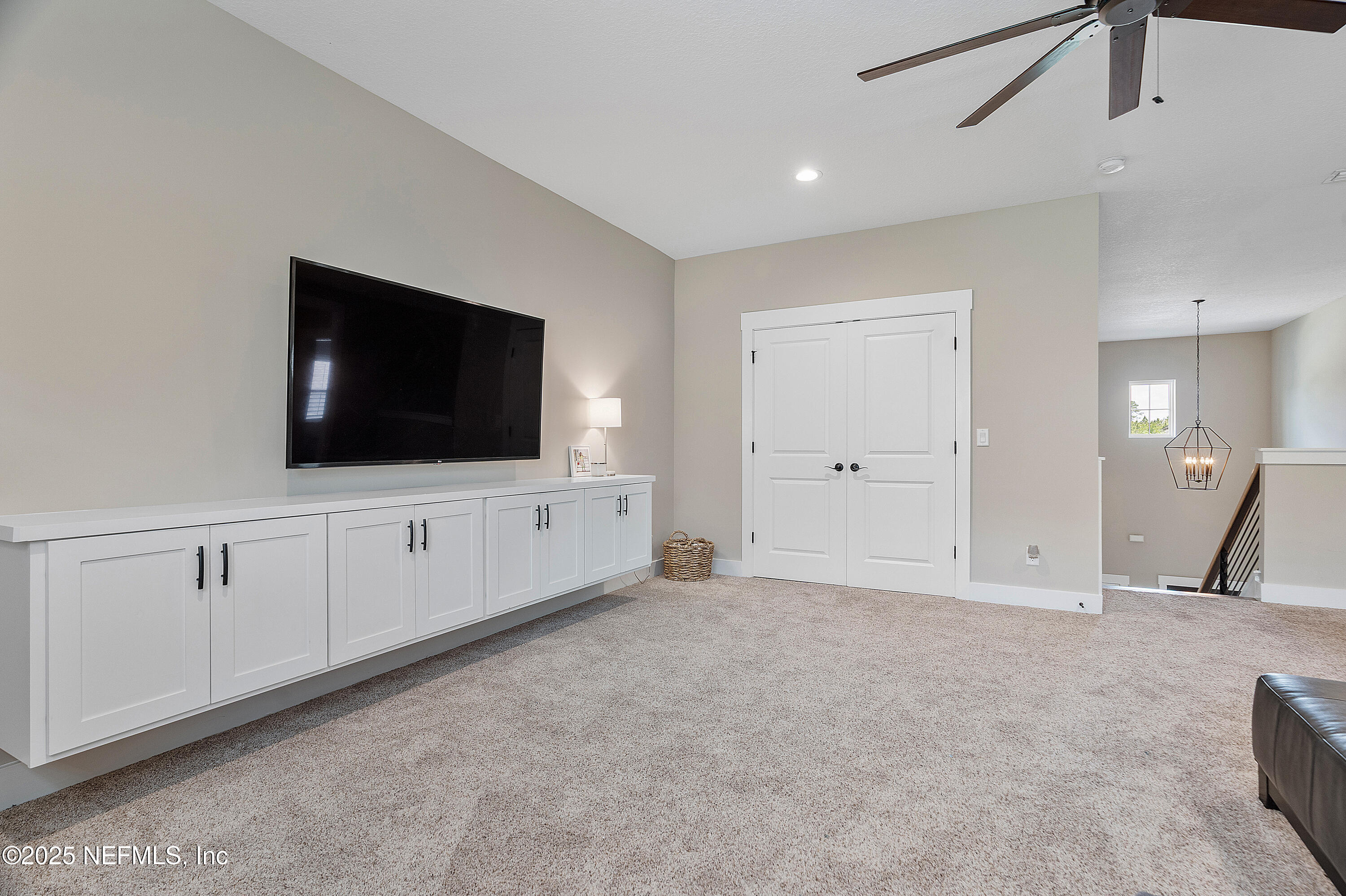 295 Seahill Drive St. Augustine, FL 32092 - Photo 55 of 101 a living room with flat screen tv and white walls