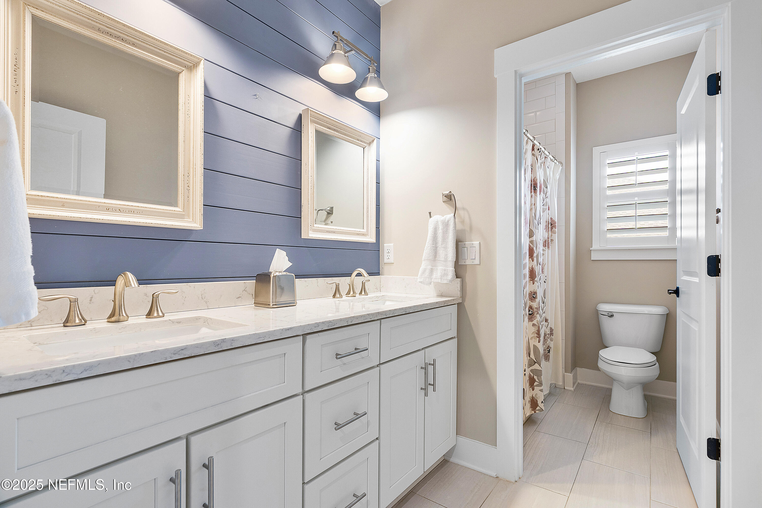 295 Seahill Drive St. Augustine, FL 32092 - Photo 61 of 101 a bathroom with a toilet sink double vanity and mirror