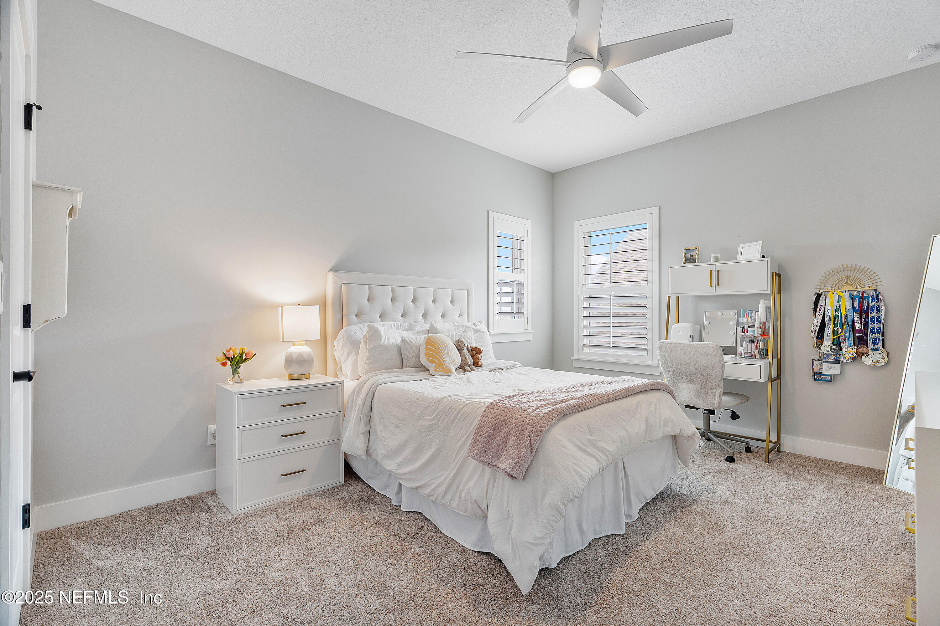 295 Seahill Drive St. Augustine, FL 32092 - Photo 62 of 101 a bedroom with a bed and a chandelier
