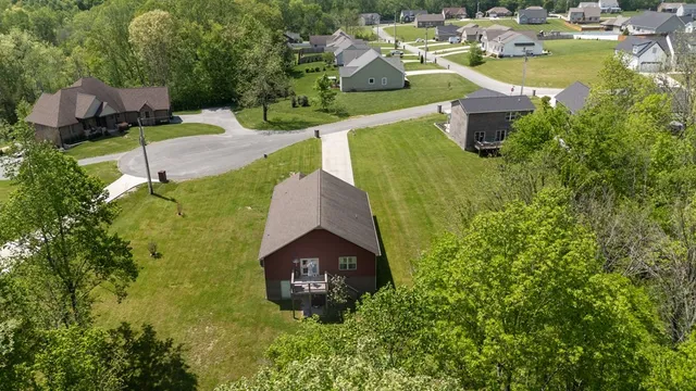 an aerial view of a house with yard swimming pool and outdoor seating