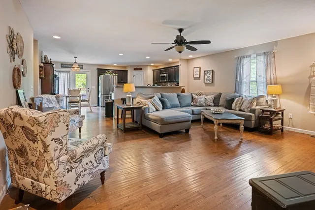 a living room with furniture and a wooden floor