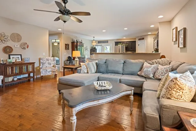 a living room with furniture and a wooden floor