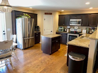 5006 Jimmie Neal Road Baxter, TN 38544 - Photo 9 of 22 a kitchen with stainless steel appliances granite countertop a refrigerator stove and sink