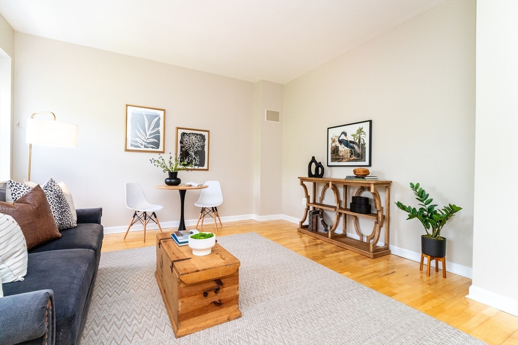 60e Glen Road, Unit 306 Brookline, MA 02445 - Photo 7 of 27 a living room with furniture and a table