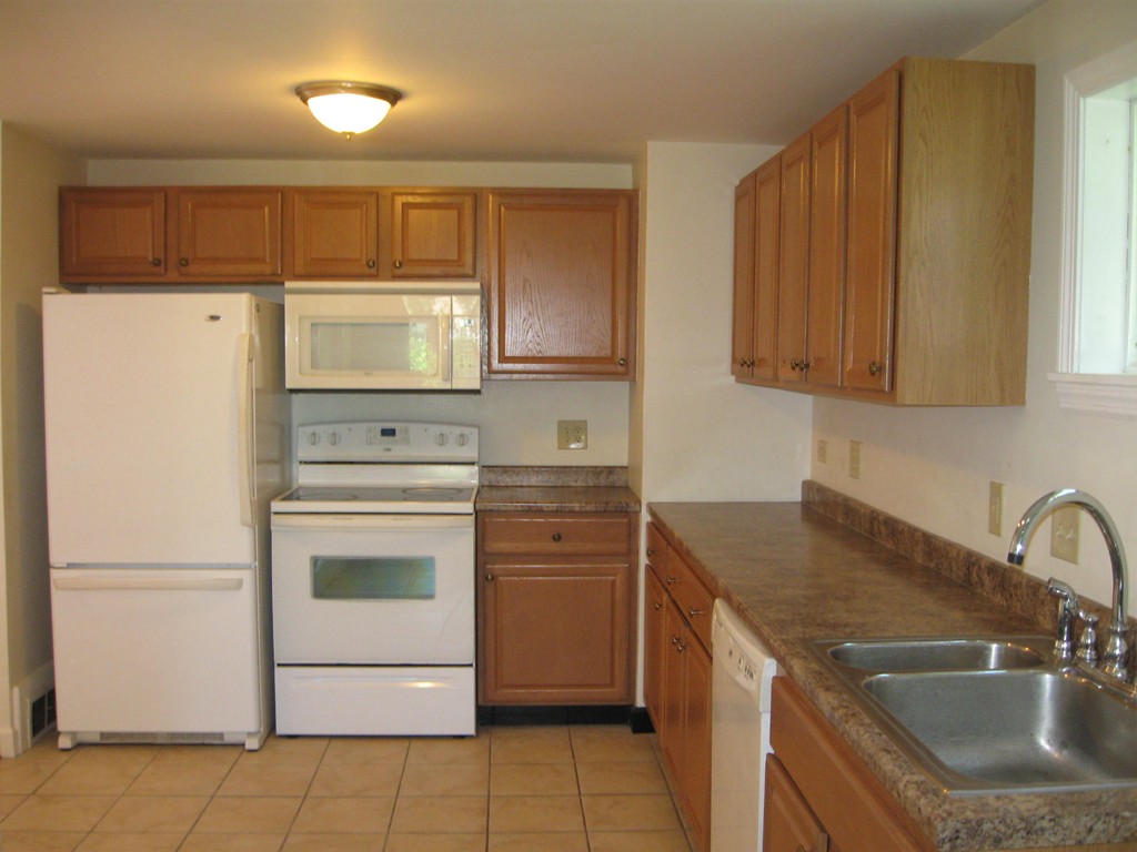 62 Garland Street Springfield, MA 01118 - Photo 9 of 26 a kitchen with a stove sink and refrigerator