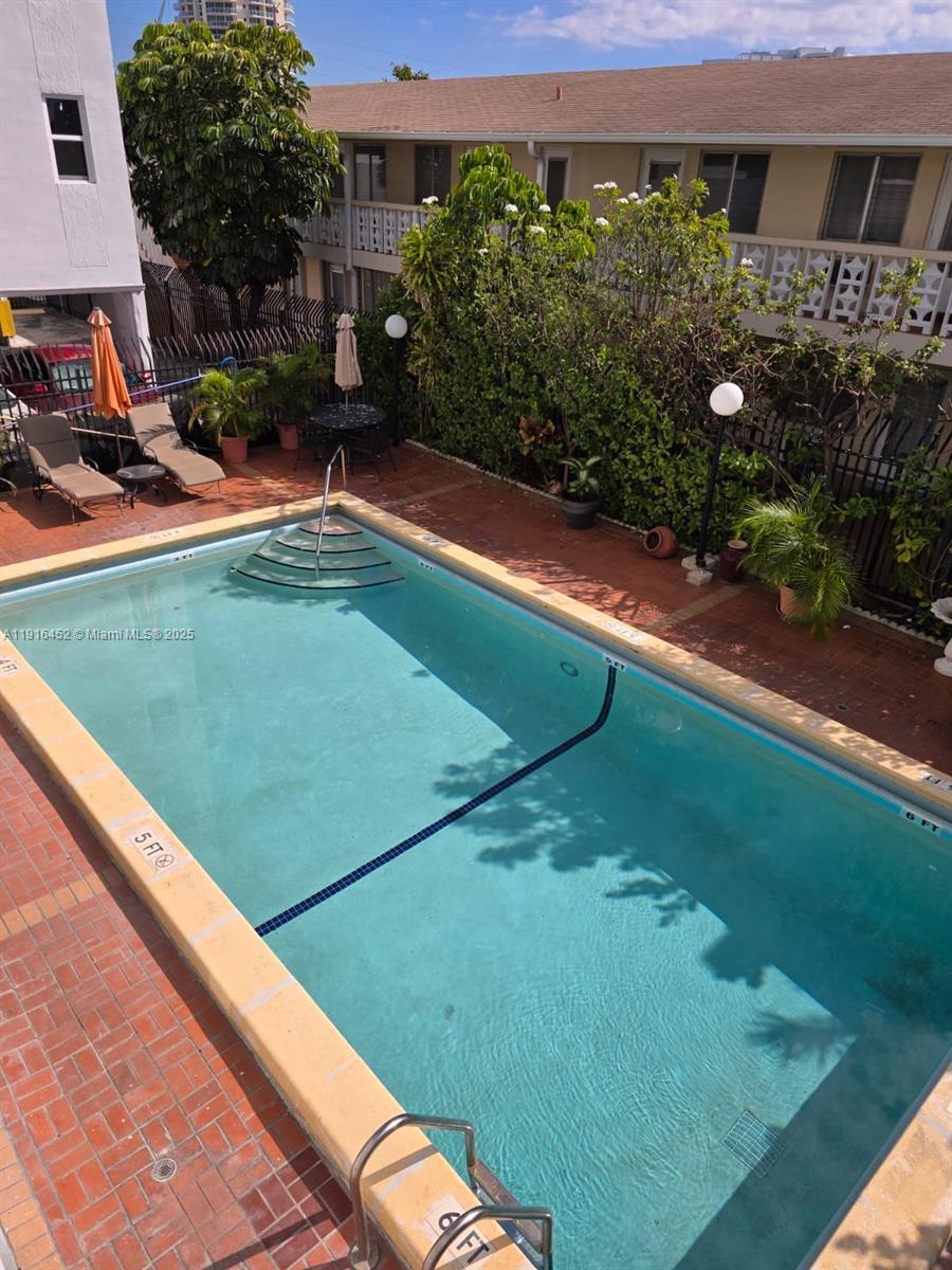 7440 Harding Avenue, Unit 204 Miami Beach, FL 33141 - Photo 12 of 37 a view of a backyard with plants and a patio