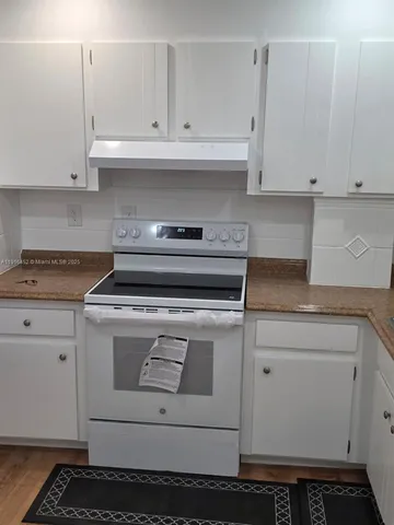 a view of cabinets and wooden floor