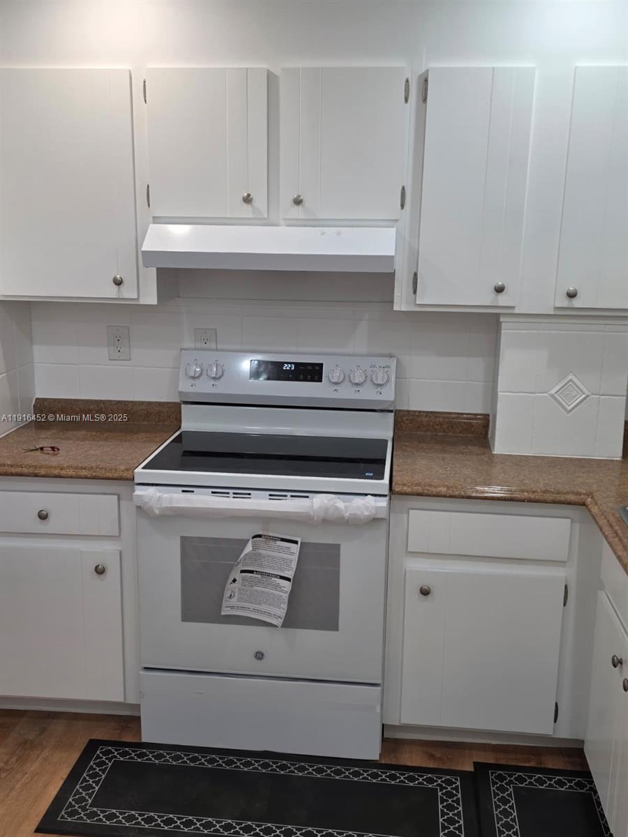 7440 Harding Avenue, Unit 204 Miami Beach, FL 33141 - Photo 16 of 37 a stove top oven sitting inside of a kitchen