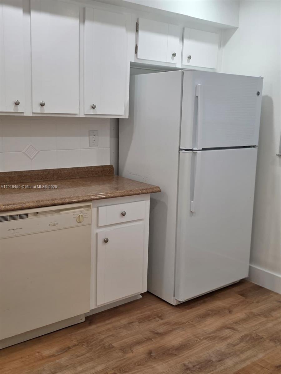 7440 Harding Avenue, Unit 204 Miami Beach, FL 33141 - Photo 17 of 37 a view of cabinets and wooden floor