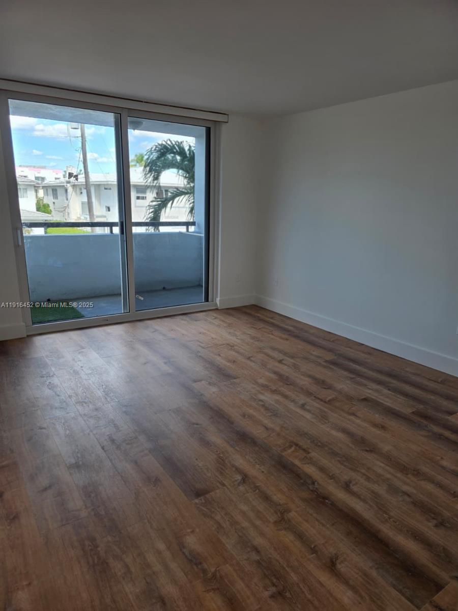 7440 Harding Avenue, Unit 204 Miami Beach, FL 33141 - Photo 21 of 37 an empty room with windows