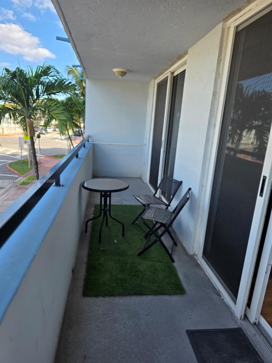 7440 Harding Avenue, Unit 204 Miami Beach, FL 33141 - Photo 28 of 37 a view of balcony with chair and wooden floor