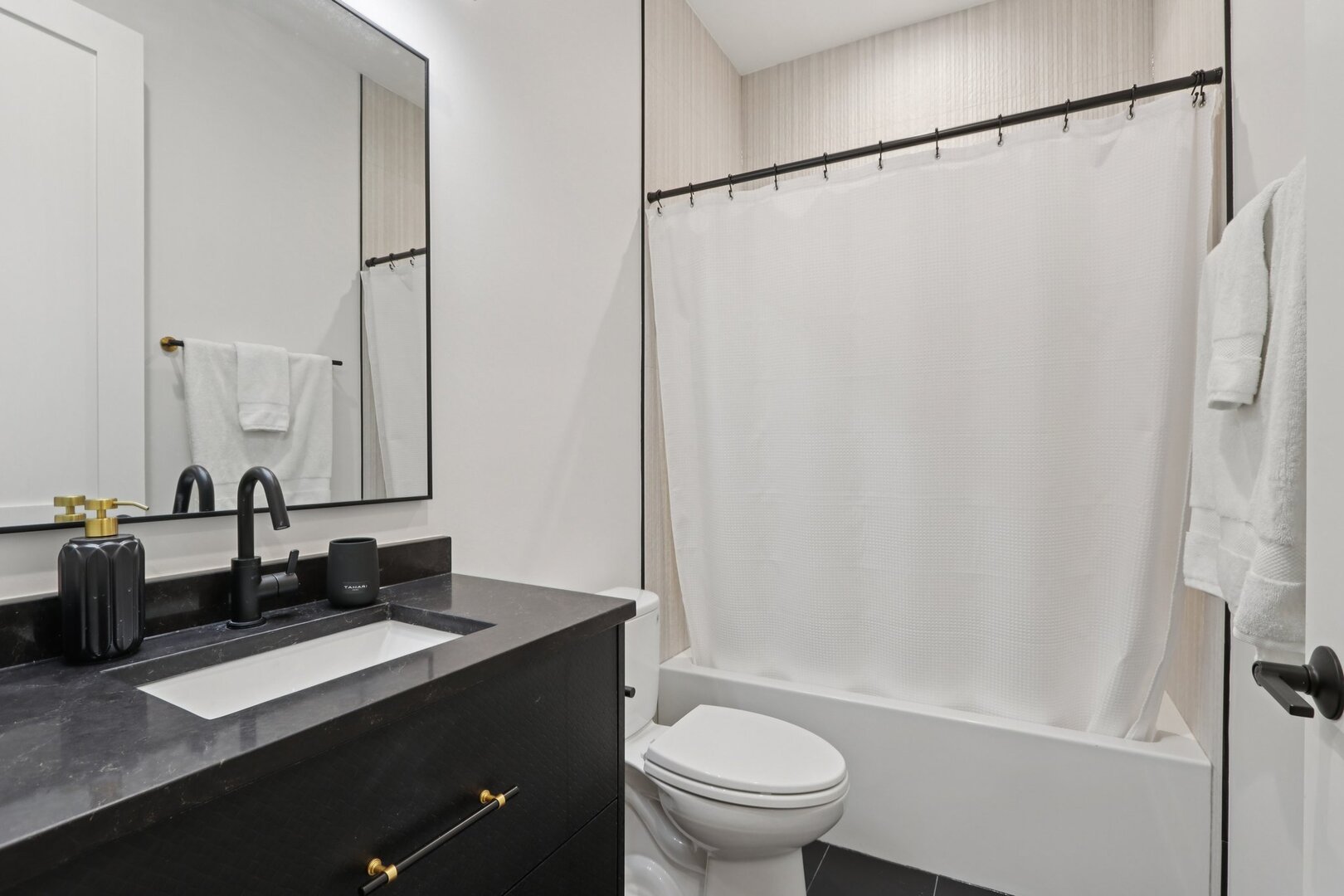 4119 North Ashland Avenue, Unit 3N Chicago, IL 60613 - Photo 12 of 33 a bathroom with a double vanity sink toilet mirror and shower