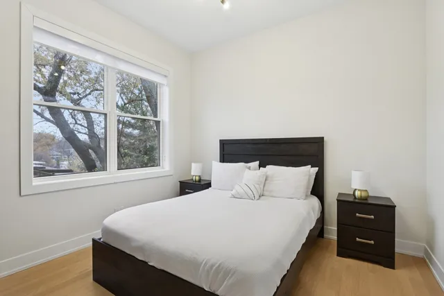 a bedroom with a bed and a window