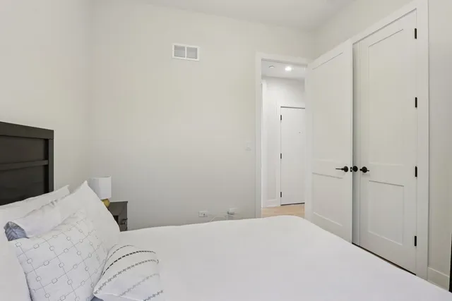 a view of a bedroom with wooden floor