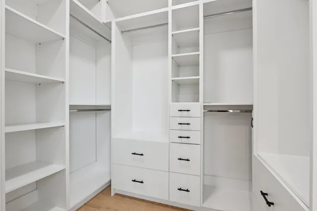 a spacious bedroom with a large bed and a large window