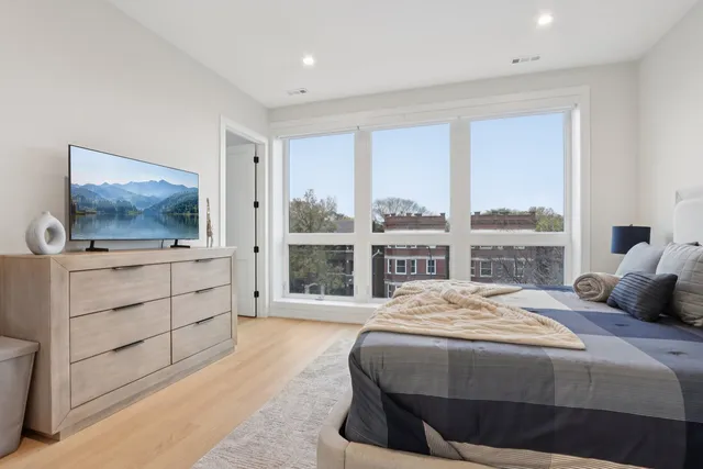 a spacious bathroom with a granite countertop sink a mirror and shower