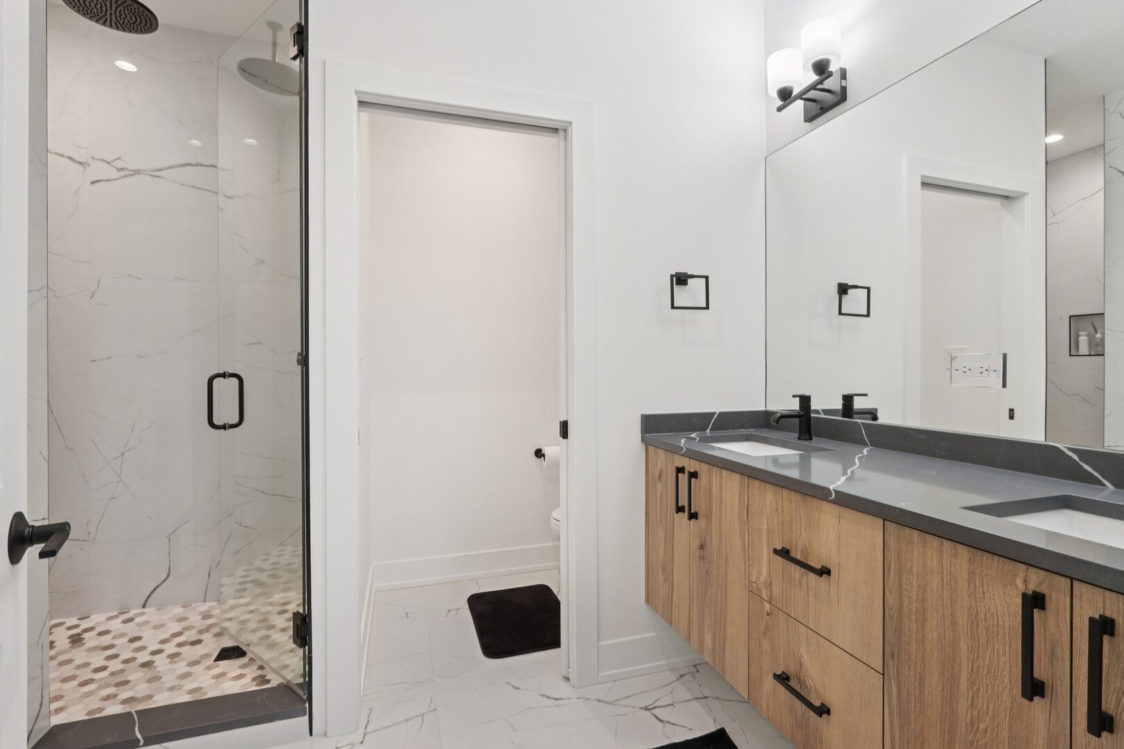 4119 North Ashland Avenue, Unit 3N Chicago, IL 60613 - Photo 22 of 33 a spacious bathroom with a granite countertop sink a mirror and shower