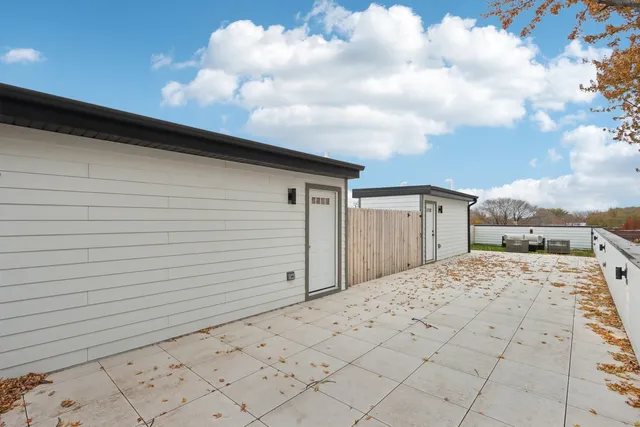 a view of a brick house with a small yard
