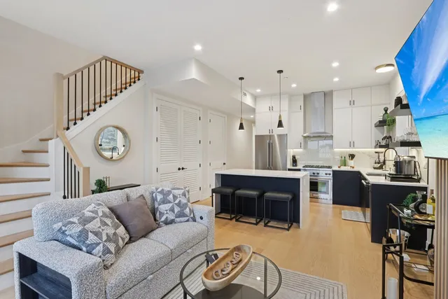 a kitchen with a sink a stove and a refrigerator