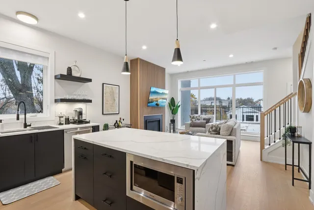a kitchen with white cabinets and stainless steel appliances
