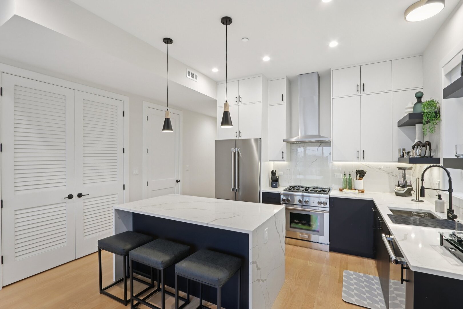 4119 North Ashland Avenue, Unit 3N Chicago, IL 60613 - Photo 8 of 33 a kitchen with white cabinets and stainless steel appliances
