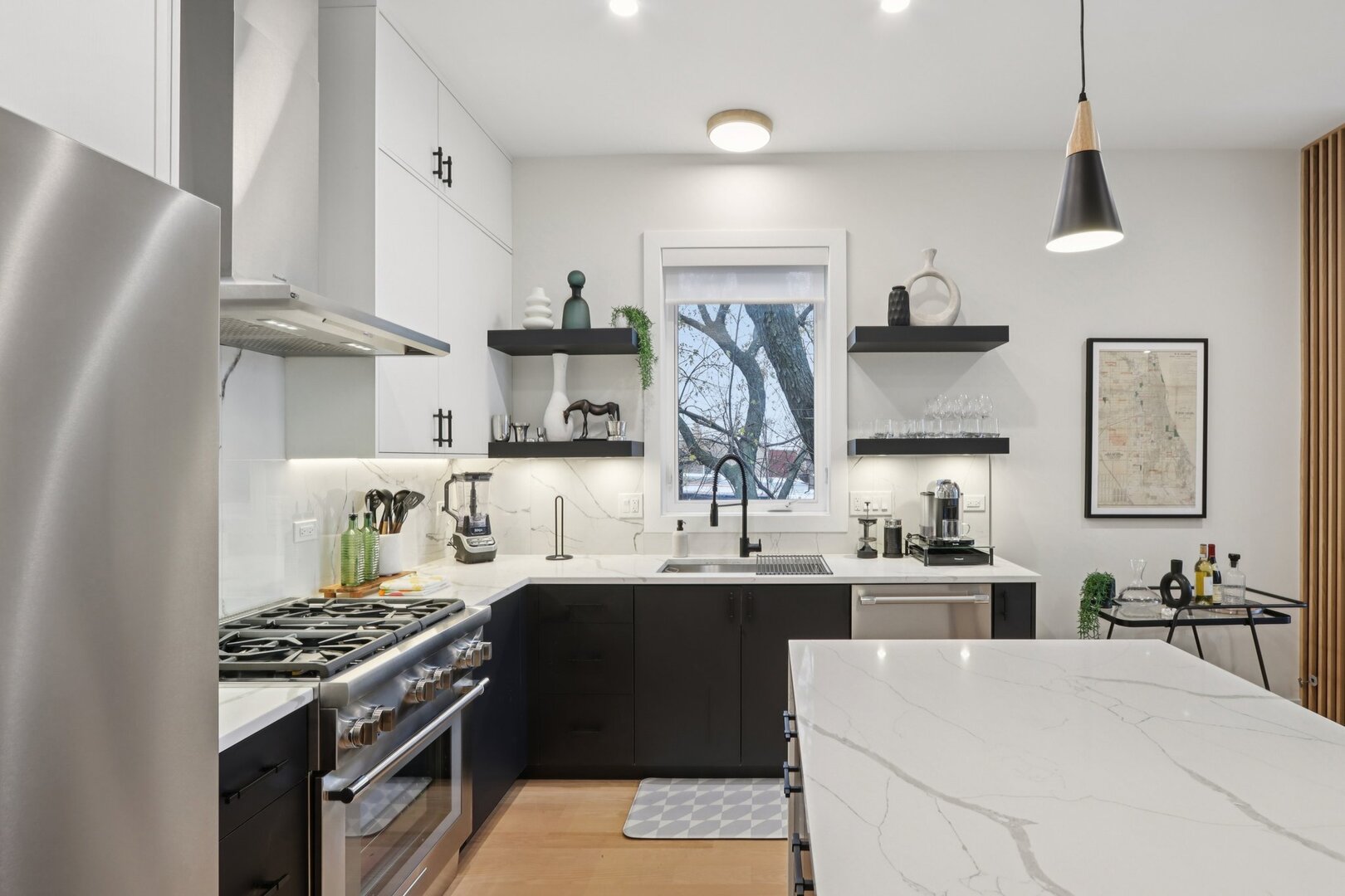 4119 North Ashland Avenue, Unit 3N Chicago, IL 60613 - Photo 9 of 33 a kitchen with stainless steel appliances a sink stove and refrigerator