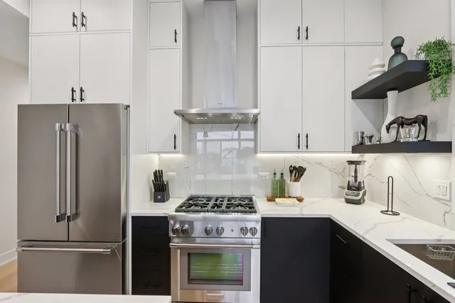 a bathroom with a double vanity sink toilet mirror and shower