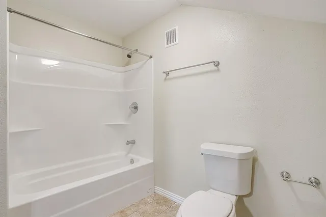a bathroom with a toilet and a bathtub