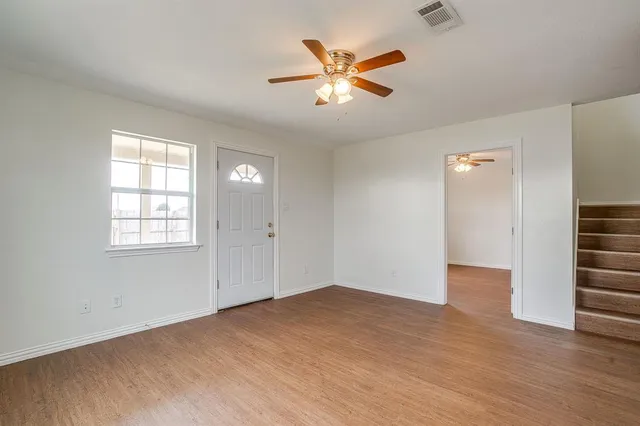 wooden floor in an empty room with a window