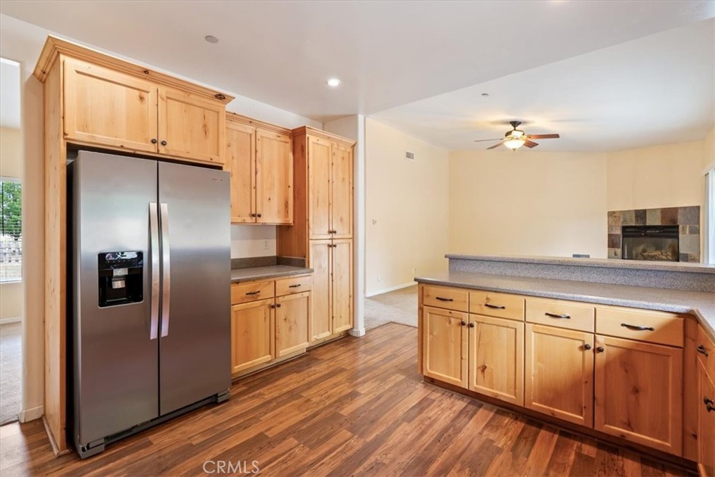 76846 Ranchita Canyon Road San Miguel, CA 93451 - Photo 15 of 51 a kitchen with stainless steel appliances granite countertop a refrigerator a stove and a sink with wooden floor