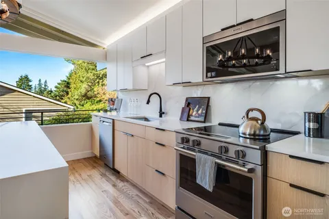 a kitchen with stainless steel appliances granite countertop a sink and a stove top oven