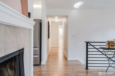 a view of a hallway with wooden floor and staircase