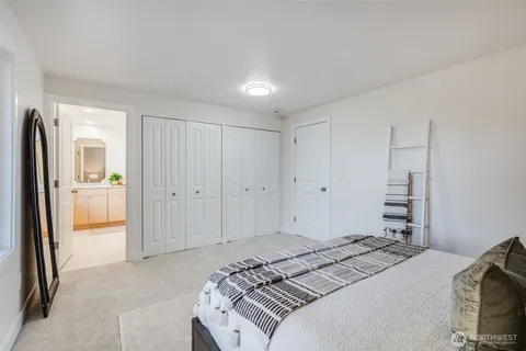 a bedroom with a bed and a view of bathroom