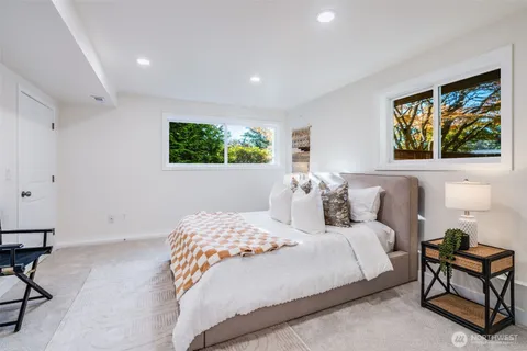 a bedroom with a bed and a chair