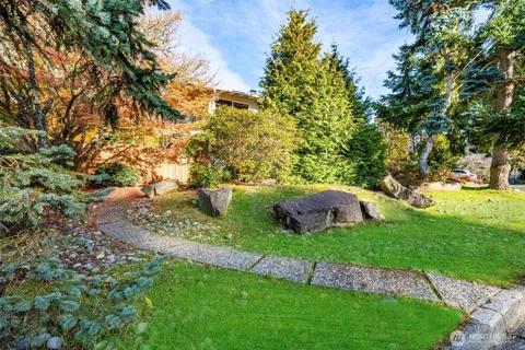 a view of a backyard with sitting area
