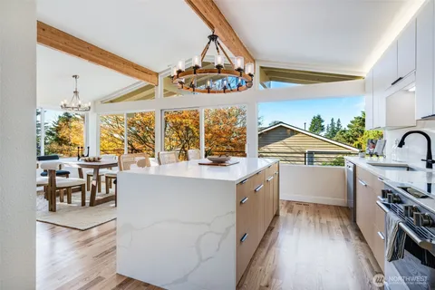 a kitchen with stove a sink and cabinets