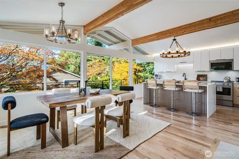 a room with stainless steel appliances kitchen island granite countertop furniture and a large window